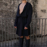 The Glade model wears a black men's skirt and oversized shirt for men